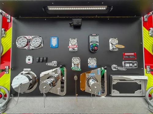 Close-up of rear pump controls, switches, and gauge cluster.